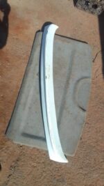 Used boot spoiler mounted on the rear edge of a Fiat Sienna, viewed from an angled side perspective.Used boot