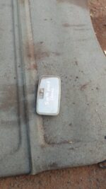 Used car roof light viewed from the side showing mounting points and wiring harness.Used car roof light viewed