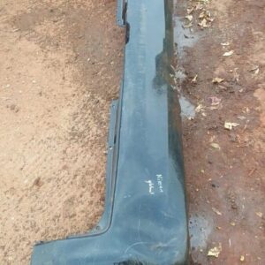 Rear view of a used Nissan NP200 rear bumper, clean with minor wear, positioned against a white background.Rea