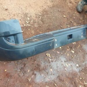 Rear bumper for Nissan NV350, used condition, shown from a front angle with mounting points visible.Rear bumpe