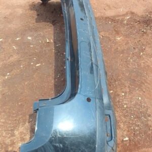 Rear bumper of a 2012 Renault Duster, used condition, shown from a slightly angled rear view.Rear bumper of a