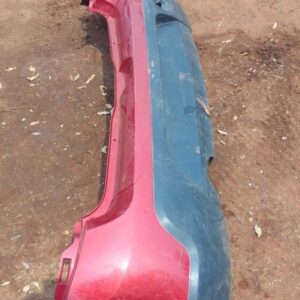 Used rear bumper of a Renault Sandero shown from the back angle against a plain light background.Used rear bum