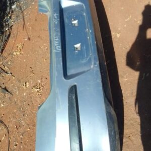 Rear view of a used rear bumper for an Opel Astra H, showing the full exterior panel and mounting points.Rear