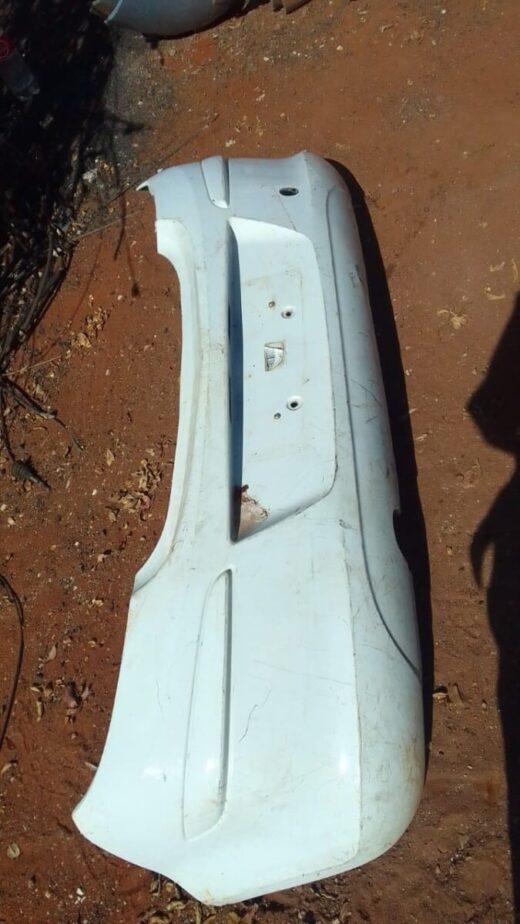 2010 Opel Corsa Essential Rear Bumper - Used Rear bumper of a 2010 Opel Corsa shown from a slight angle, used condition, with mounting points visible.Rear