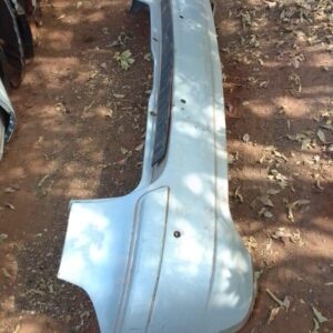 Rear view of a used rear bumper for a 2005 Mercedes W160, showing bumper curvature and mounting points.Rear vi