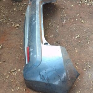 Rear bumper of a 2013 Honda Jazz shown from an angled side view, used condition.Rear bumper of a 2013 Honda Ja