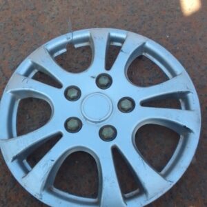 Front view of used Mazda 3 wheel cap showing chrome emblem and scuffed surface.Front view of used Mazda 3 whee